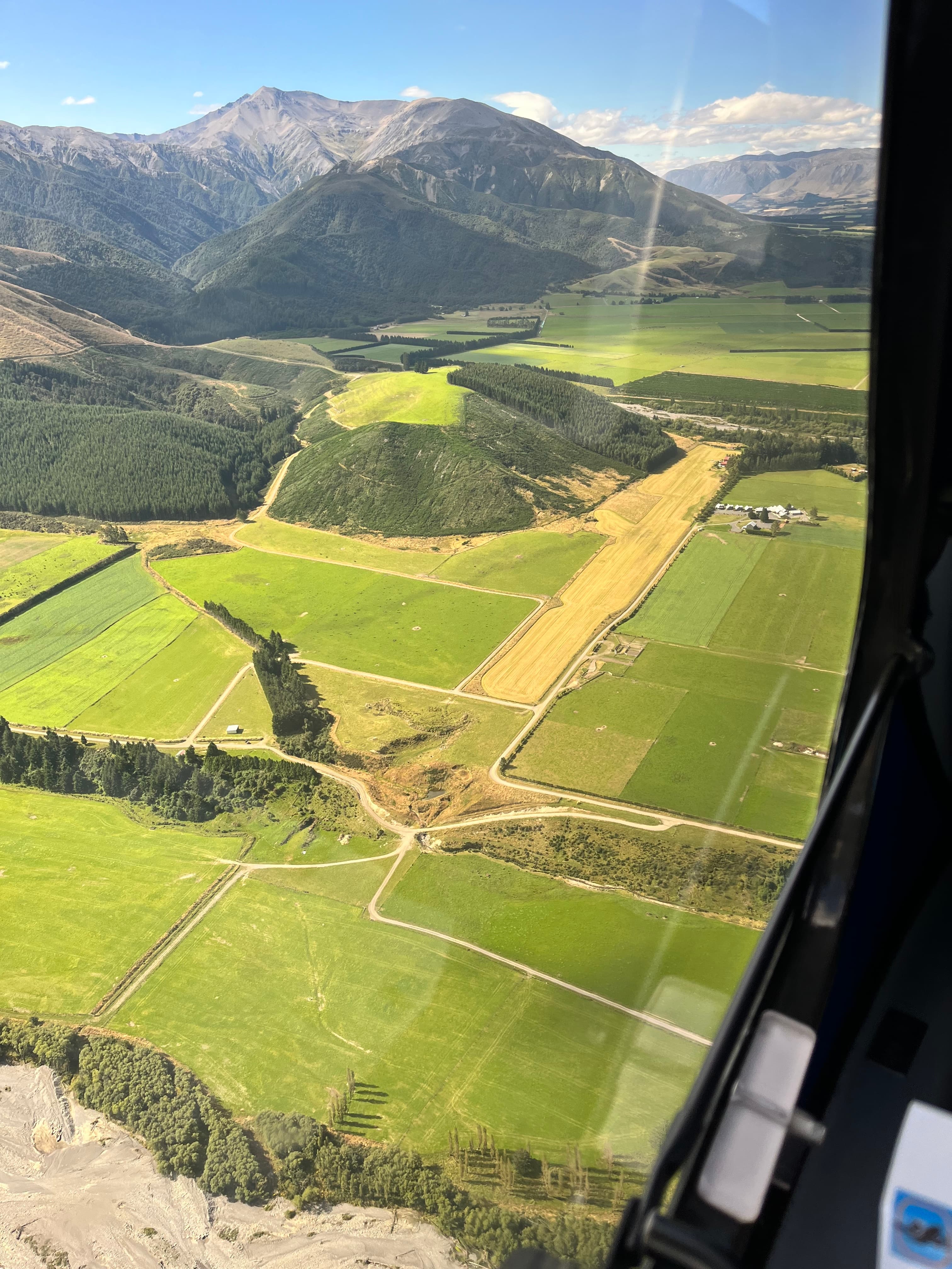 Aerial view of rural landscape with mountains and fields