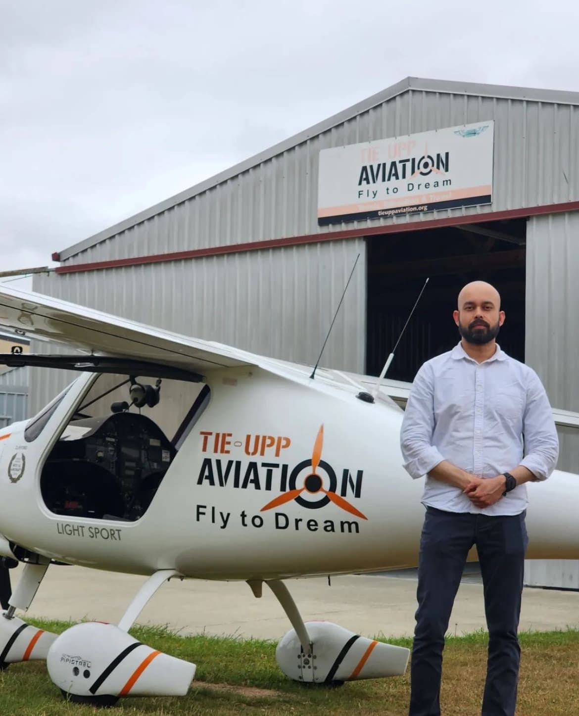 Pilot standing next to light sport aircraft